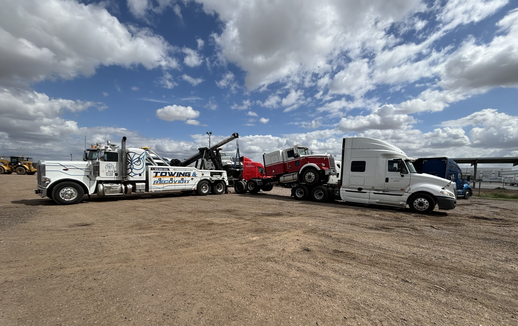 two-trucks-towing-yard